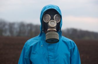 portrait of ecologist working outdoors wearing gas mask and uniform scientist explores surroundings scientist works in open air 176532 9824