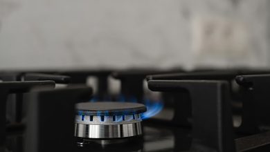 modern kitchen stove natural gas burns with blue flame household gas consumption close up selective focus